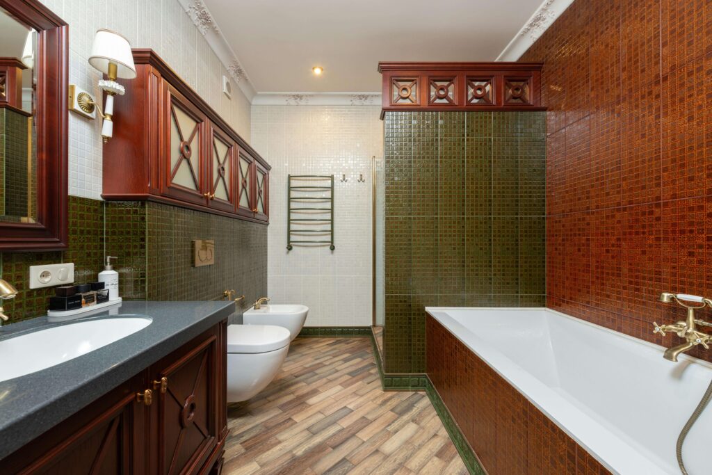 Mediterranean bathroom with wooden shelves and colorful tails