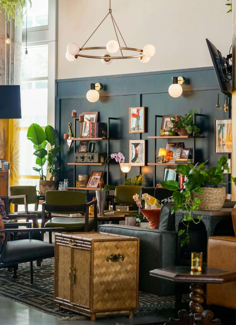 Mid Century Eclectic Living Room with dark green walls and golden lamp