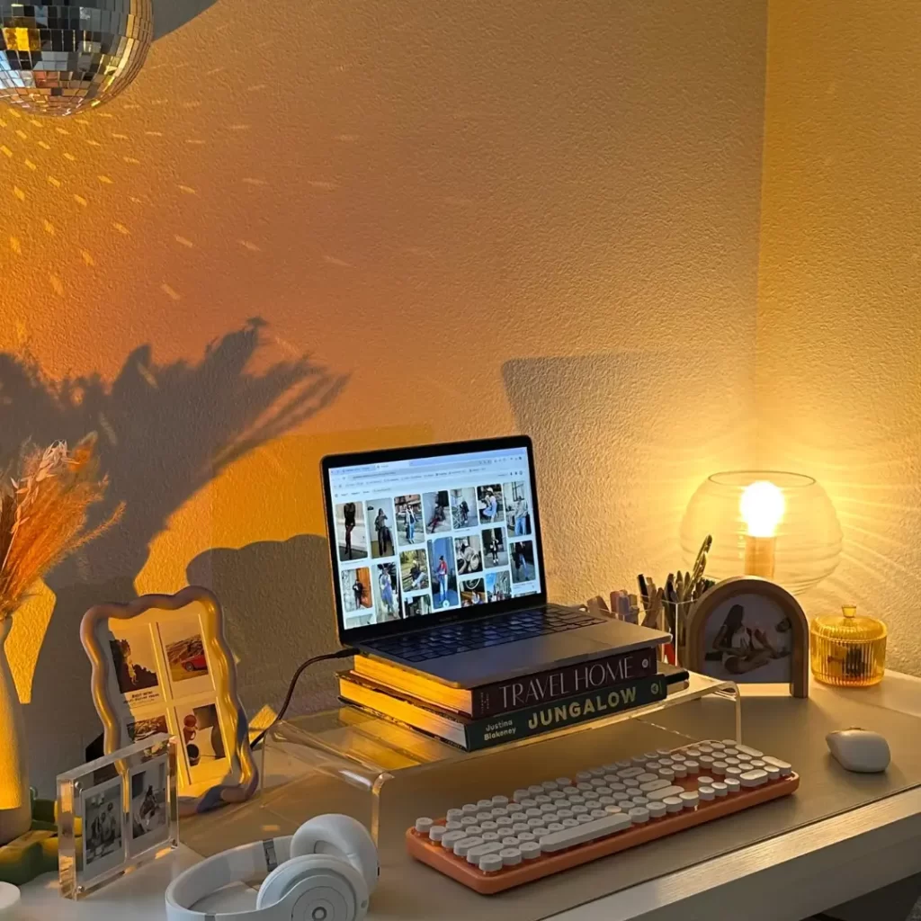 A close-up of a laptop displaying a digital calendar, accompanied by a minimalist headphone stand with over-ear headphones, showcasing a structured and organized work schedule.